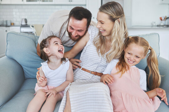 Love, Parents And Happy Family With Children On Sofa Laughing For Fun, Bonding And Leisure. Daughter, Mom And Dad With Kids In Canada Enjoy Playful And Excited Smile Together In Living Room.