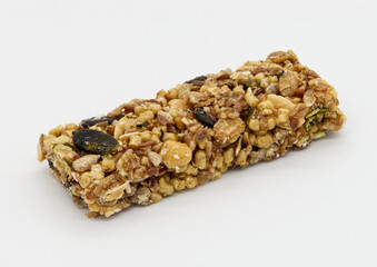 Protein bar with whole grains peanuts and cranberries isolated on white background.