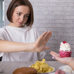 Portrait of a beautiful middle-aged brunette woman promoting the rejection of unhealthy diet and harmful junk products