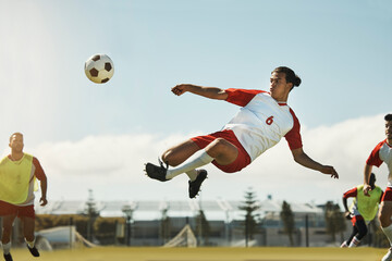 Soccer, game and man kicking a ball during training with the team on a field for sports. Athlete...
