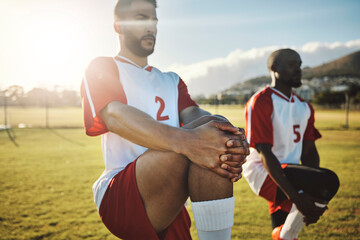 Soccer, football and team stretching legs for match warm up, game or practice. Sports, group and men stretch outdoor on pitch preparing for training, exercise or workout on grass field outdoors.