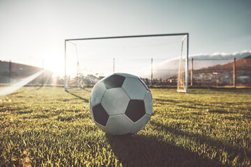 Soccer ball, goal post and grass on sports field, wellness club or fitness center for exercise, training or Brazilian game. Zoom, texture and football for workout, stadium competition or energy match