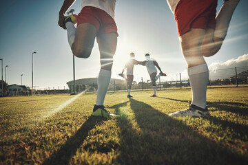 Soccer, team and stretching together on sport field for exercise, wellness and workout practice for game day. Football, health and teamwork prepare for training, motivation and fitness before playing