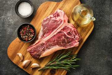 T-bone or porterhouse raw steak of beef cut from the short loin. Steak include T-shaped bone with meat on each side. Porterhouse steaks are cut from the rear end of the short loin.