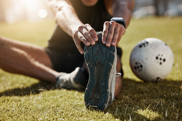 Stretching, foot and soccer man on field for sports training, exercise wellness or legs muscle...