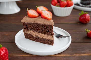 Naked chocolate cake with cream and fresh strawberries on top. Rustic style. Selective focus. Copy space.