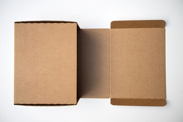 Cardboard crab box in an open form on a white isolate. White background with a rectangular box. Delivery of parcels. Postal delivery. Open the cardboard box.