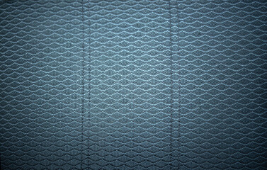 Photo of the texture of the car seat fabric in dark color. Fabric for the seat covering in a...