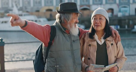Love, travel and old couple reading a map and pointing to a direction on their adventure journey on holiday vacation. Tourism, lifestyle and Asian woman searching for a location together in Cape Town