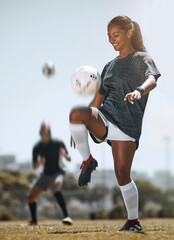 Football, sports and training with woman juggling with knees for workout, exercise and fitness on...