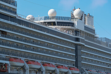 HAL cruiseship or cruise ship liner Nieuw Amsterdam at San Diego terminal for Mexican Riviera cruising with downtown skyline blue sky sunny day	