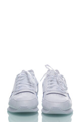 Pair of of New White Sneakers Placed Against White Background.