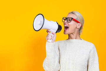 Management ideas. Portrait of One Winsome Caucasian Expressive Blond Woman in Glasses Shouting At Megaphone isolated on Yellow.