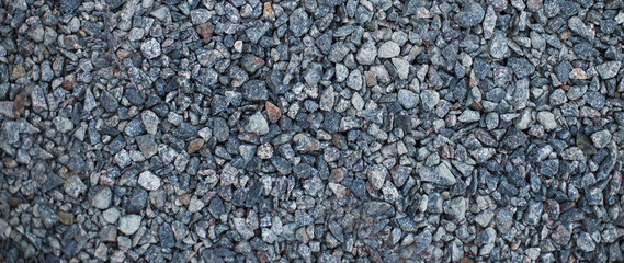Gray small gravel background texture. black road stone and rocks.