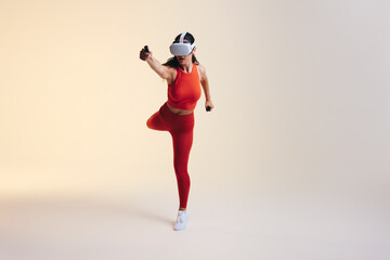 Fototapeta na wymiar Staying fit in the metaverse. Woman doing a fitness workout with a vr headset