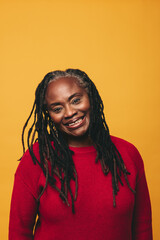 Portrait of a happy mature woman smiling at the camera in a studio