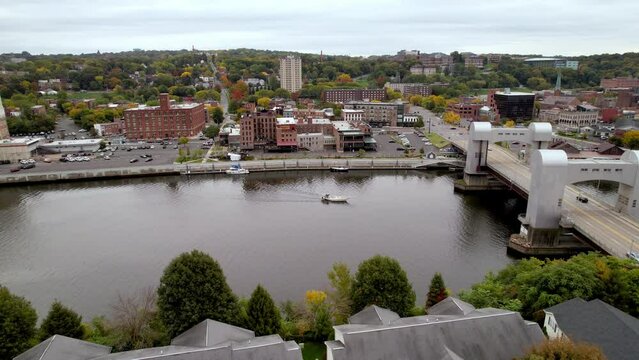 AERIAL OVER BRIDGE AND BOAT ALONG HUDSON RIVER IN TROY NY, NEW YORK