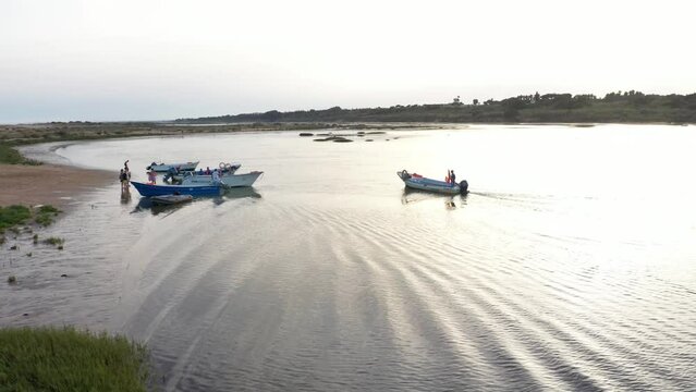Boats On The Shore Of Ria Formosa At Sunset In Algarve, Portugal - aerial drone shot