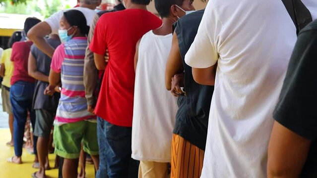 A group of people in line with different clothes.