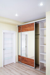 Wardrobe with mirror. Interior of modern empty wardrobe room. 