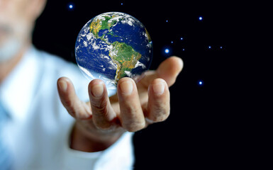 NASA globe in male hand on black background