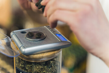 Small pieces of CBD Hashish on a scale. Cannabis extract. Alternative herbal medicine concept. High quality photo