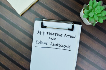 Concept of Affirmative Action and College Admissions write on paperwork isolated on Wooden Table.