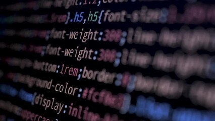 4K Close-up shot programming tag code on PC Monitor scroll down. Background concept for programming and coding web development. Editing CCS style. Side view, macro static shot.