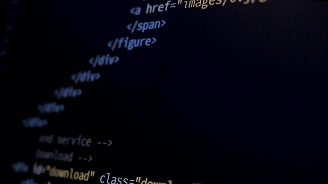 4K Close-up shot HTML tag code on PC Monitor scroll down. Background concept for programming and coding web development. Clean side view, macro static shot.