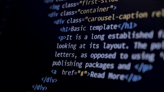 4K Close-up shot HTML tag code on PC Monitor scroll down. Background concept for programming and coding web development.
