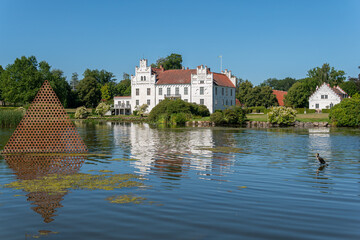Fototapeta na wymiar Sweden, Wanas – August 14, 2022: A beautiful ancient castle in front of a lake on a sunny summer day 