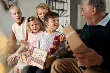 Multi generation caucasian family opening Christmas presents and having fun - Powered by Adobe