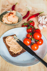 Fresh vegetarian sandwich with red pepper paste and cherry tomatoes