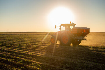 Tractor spreading artificial fertilizers