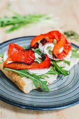 Fresh sandwich panini type with goat cheese, arugula and roast red pepper