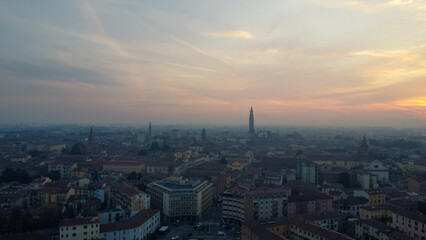 Aerial drone view of misty Cremona, Lombardy Italy medieval center at sunrise - obrazy, fototapety, plakaty