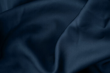 Luxury dark shiny navy blue color creased smooth satin silk cloth texture decorate background with minimalistic style and copy or negative space