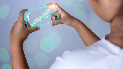 Hologram image of a candlestick chart from a phone on a person's hand. Offer trading concept, investment ideas