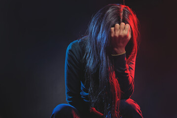Helpless, hurt, depressed young woman feeling completely crushed, dramatic studio portrait - 539404831