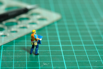 Miniature people toy figure photography. Architectural sketching process concept. A construction...