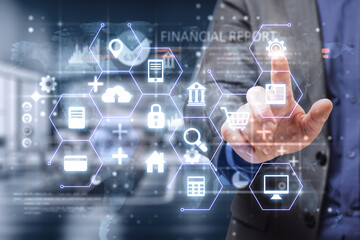 businessman hand pointing at abstract glowing business octangones and icons hologram on blurry office interior background. Finance, business report and creative interface concept. Double exposure.