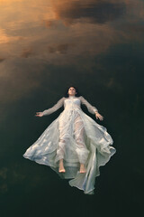 Sleeping woman floating in lake waters