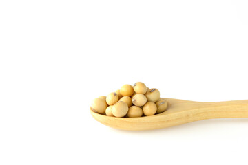 Soybeans on wooden spoon isolated on white background.