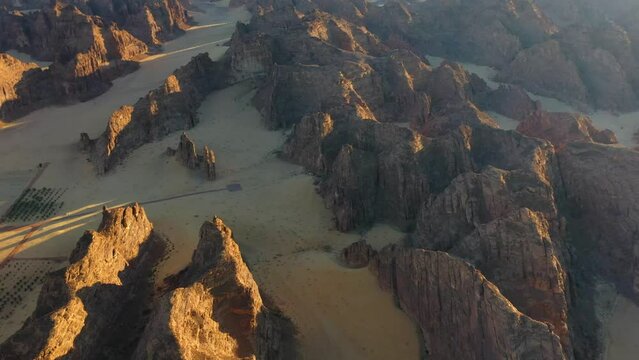Dramatic evening light on mountains in Al Ula, Saudi Arabia - circling, drone shot