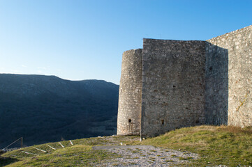 Fototapeta na wymiar Medieval stone castle surrounded with forested mountains in Drivenik, Croatia