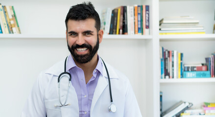 Cheerful hispanic mature doctor with beard