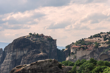 Fototapeta na wymiar Nature, geology, vegetation, architectural masterpieces, ancient relics, art, iconography, faith in God, and gigantic human efforts united here to create this unique area of Meteora complex, Greece.