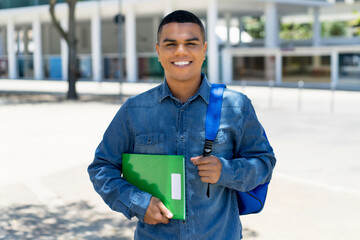 Laughing mexican male student with backpack