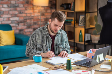 Naklejka premium Fashion designer working in his studio