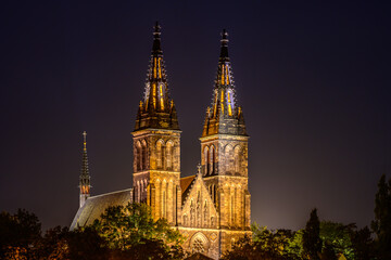 Fototapeta na wymiar Illuminated Basilica of St. Peter and St. Paul on Vysehrad hill in Prague in strong moonlight.